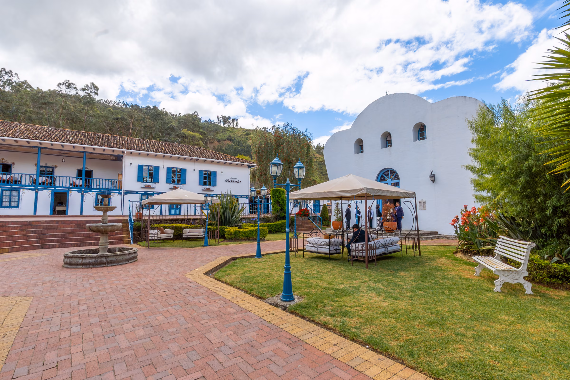 The brick plaza with its stone fountain, the house with blue galleries and the white chapel with its wavy silhouette.